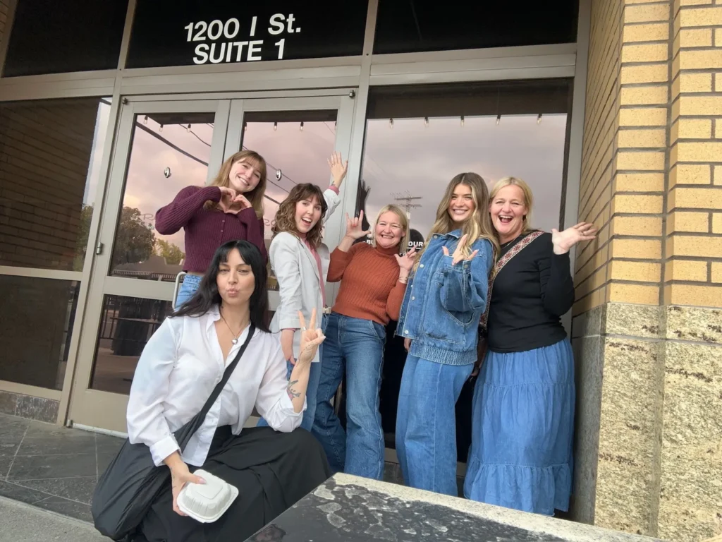 Gerbo team posing for a photo in front of a building.