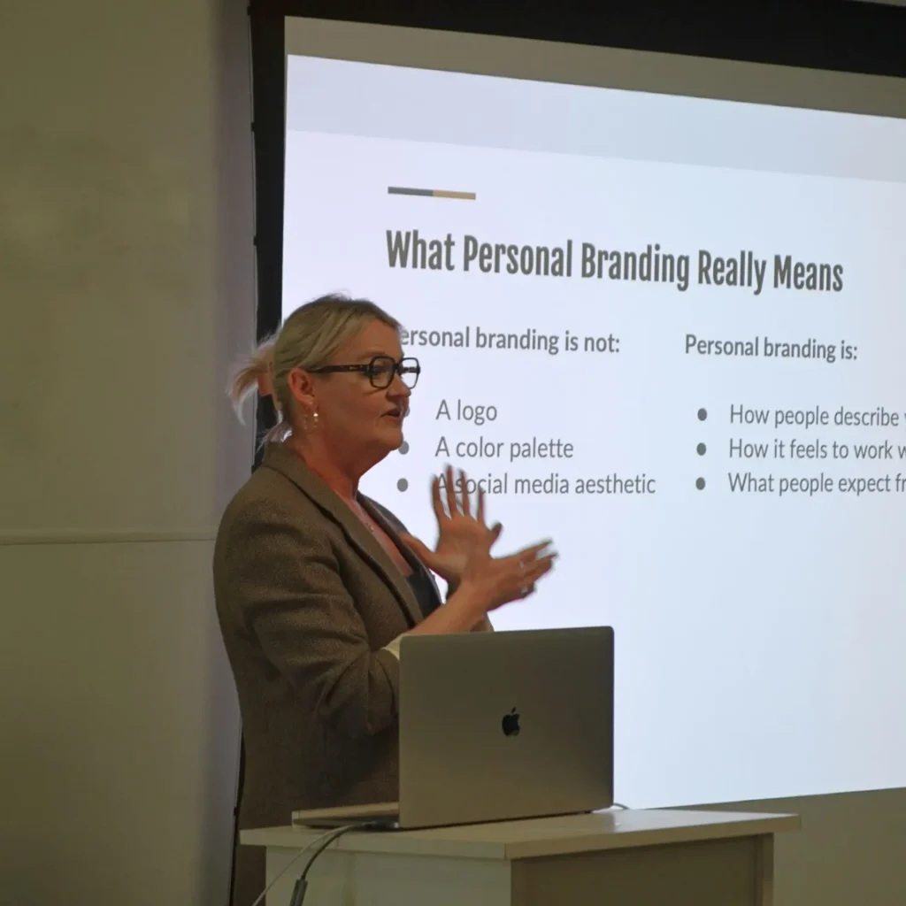 Sally Gerbo presenting a branding and marketing lecture to PMZ agents.